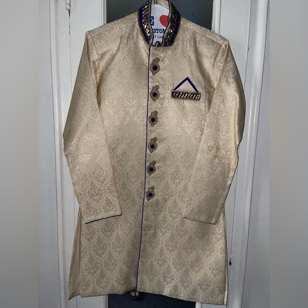 Cream and blue colored sherwani set with matching blue pants.